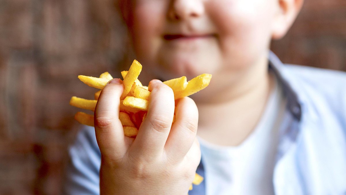 close-up-boy-holding-french-fries.jpg